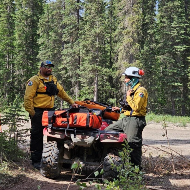 An NWT Fire photo shows an operations section chief and fire technician working on wildfire VQ001 outside Fort Good Hope.